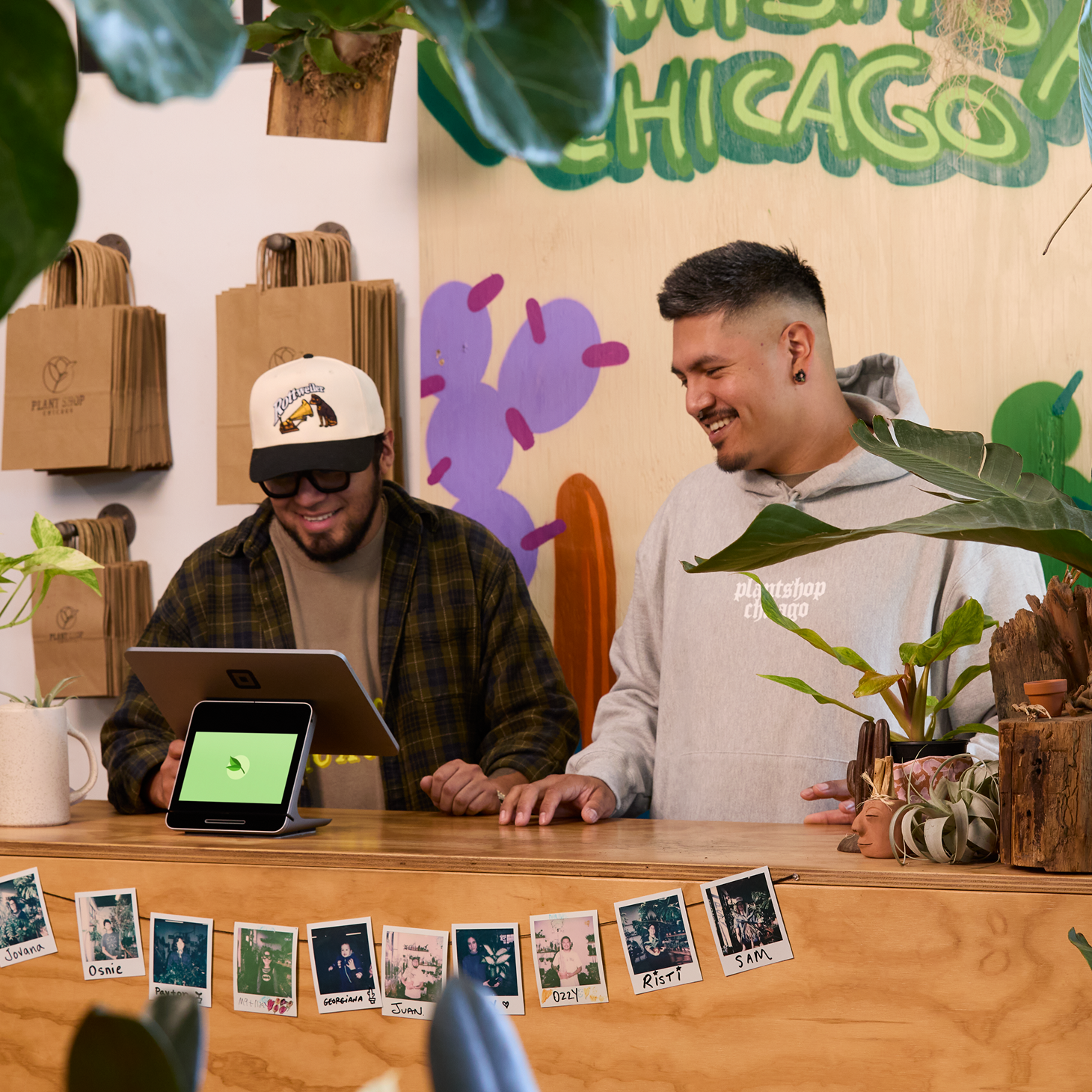 Employees of a tattoo studio with two square stands.