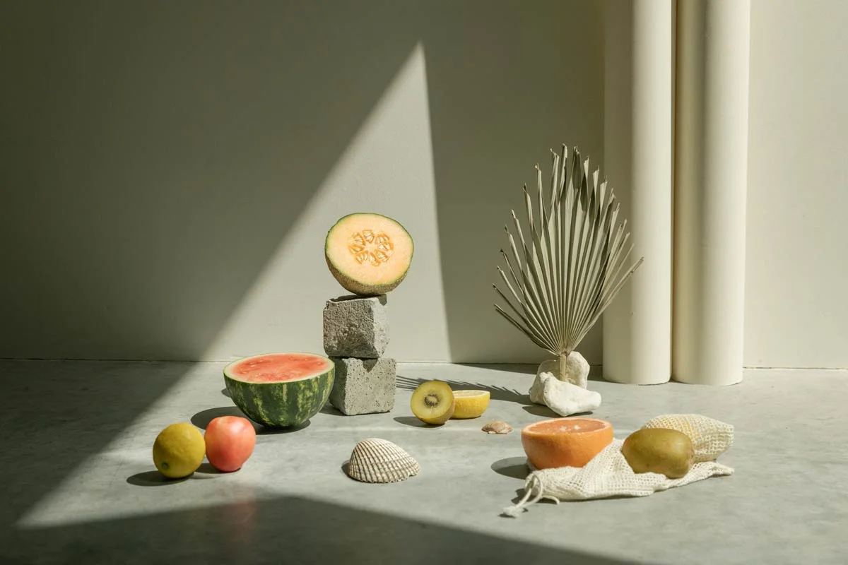 Fruit and objects on a gray ground with incident light. Light background with decorative elements. Fruit and objects on a gray ground with incident light. Light background with decorative elements.