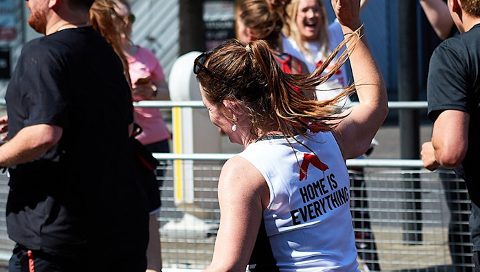 A runner wearing a Shelter top with the slogan 'Home is everything' on the back.
