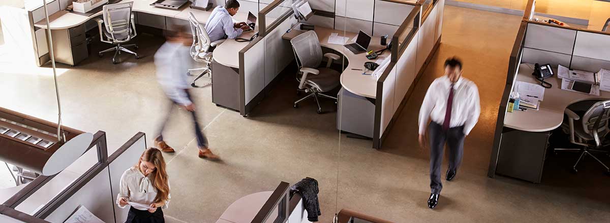 Busy, fast paced office. People walking are blurred.
