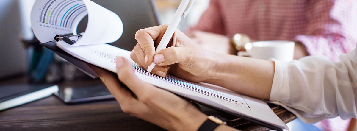 Writing on a chart on a clipboard