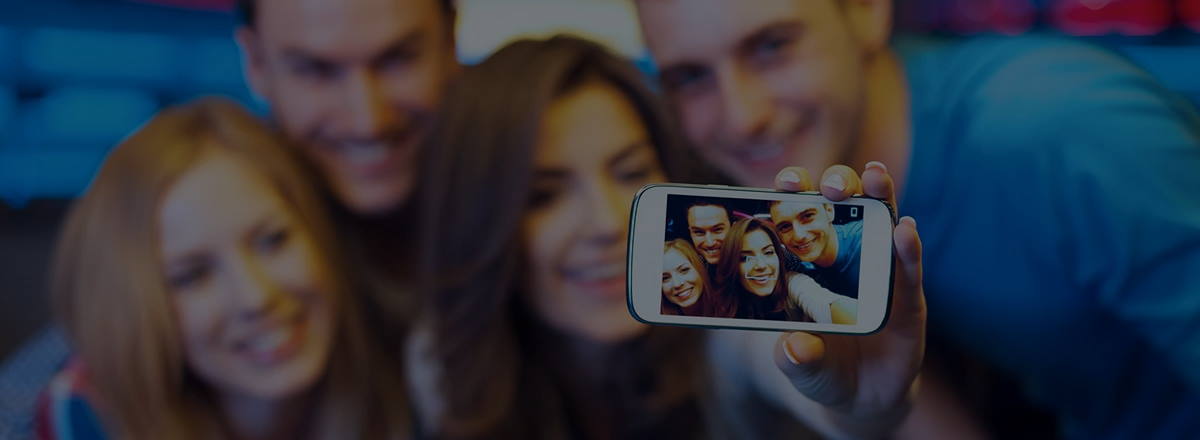 A group of people taking a selfie on a smartphone