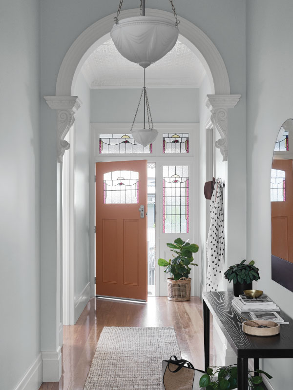 interior white hallway with peach door.