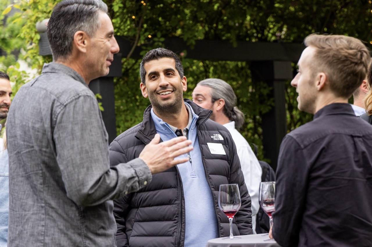 Photograph of business leaders talking outside at a conference