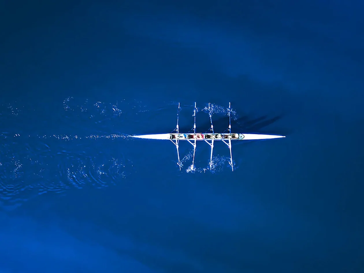 Aerial view of a rowing team in the sea waters