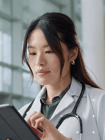 female doctor on ipad ai sparkles
