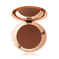 Airbrush Bronzer in Deep open An open mirrored-lid bronzer compact in a dark brown shade.