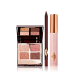Pillow Talk Eye Kit displayed Quad, mirrored-lid eyeshadow palette with shimmery brown, gold, and pink eyeshadows with a berry-brown eyeliner pencil, and black mascara with nude pink bottle and gold-coloured lid.