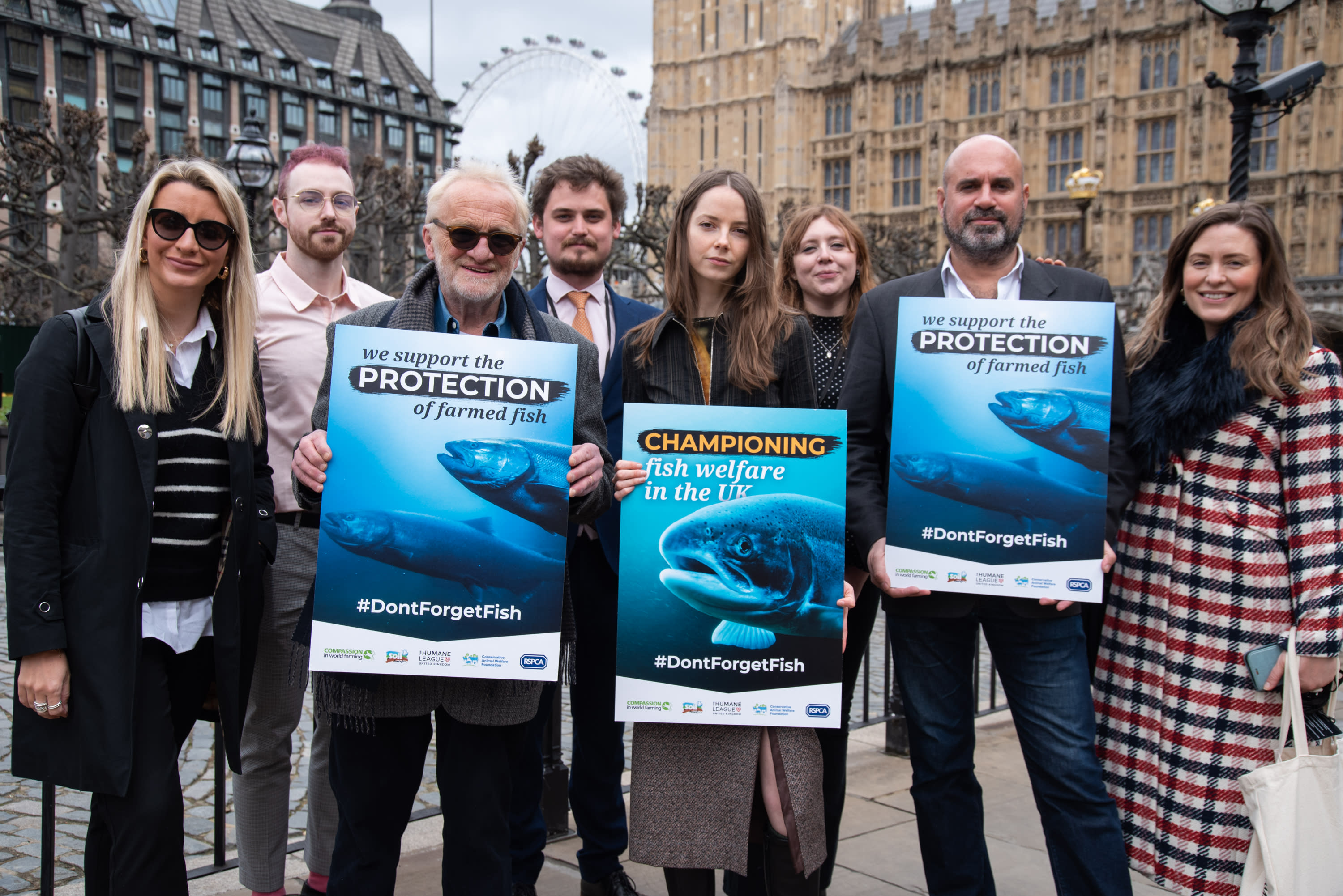 Celebrity chef Antony Worrall Thompson, TV Vet and Campaigner Marc Abraham and artist Isabella Cotier stand with placards showing factory farmed fish alongside THL staff outside Parliament.