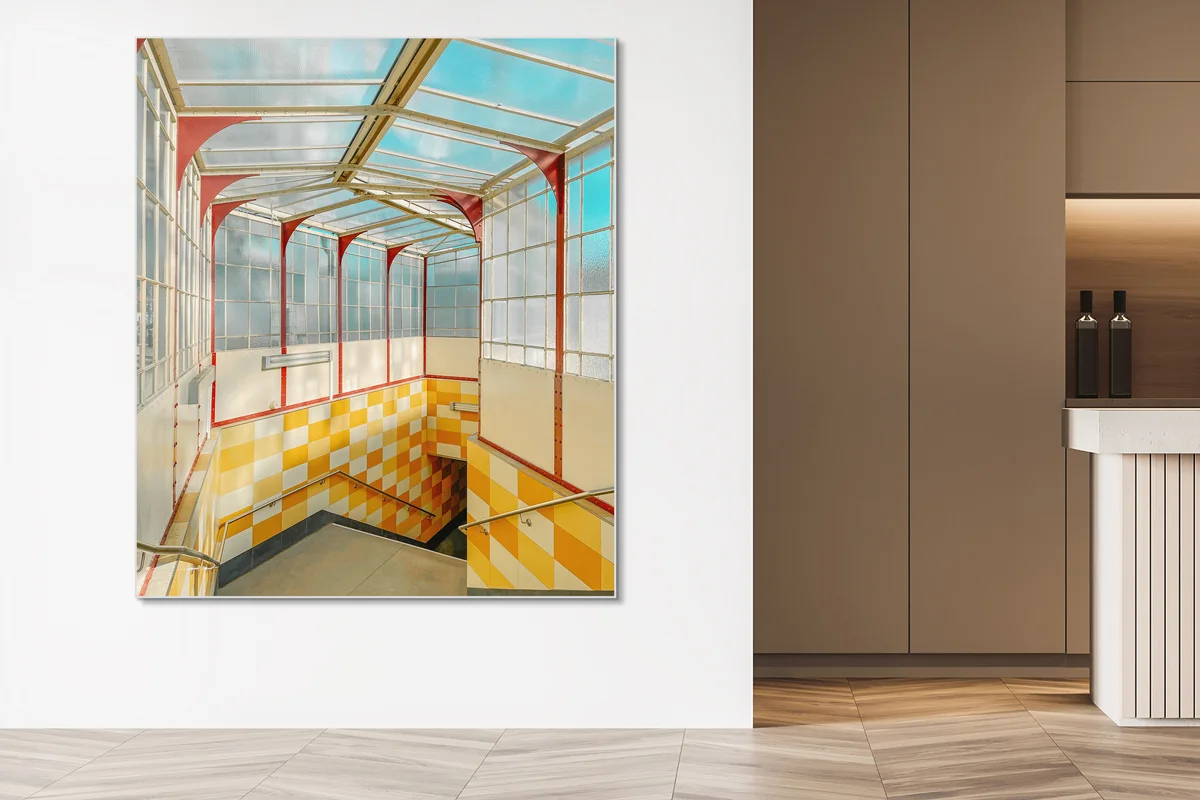 Quadratische Wandkunst mit Bild eines Treppenhauses mit Glasdach, roten Streben und gelb-weißen Fliesen.