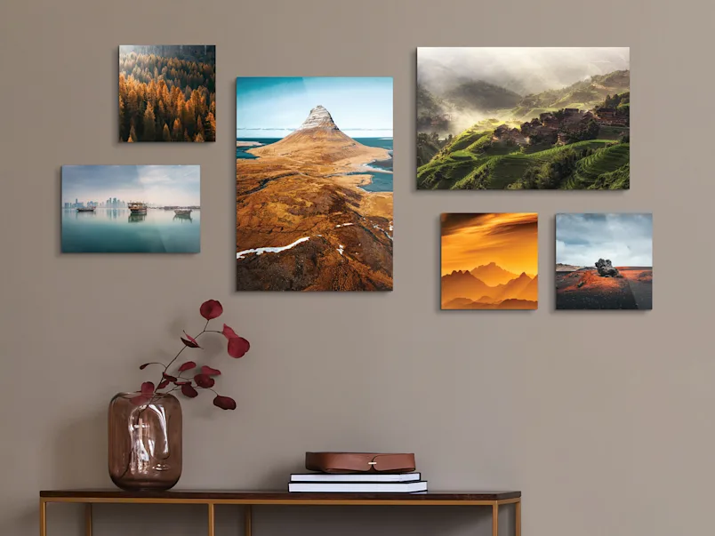 Several different motifs on Original Photo Prints On Wood on a wall in a living room.