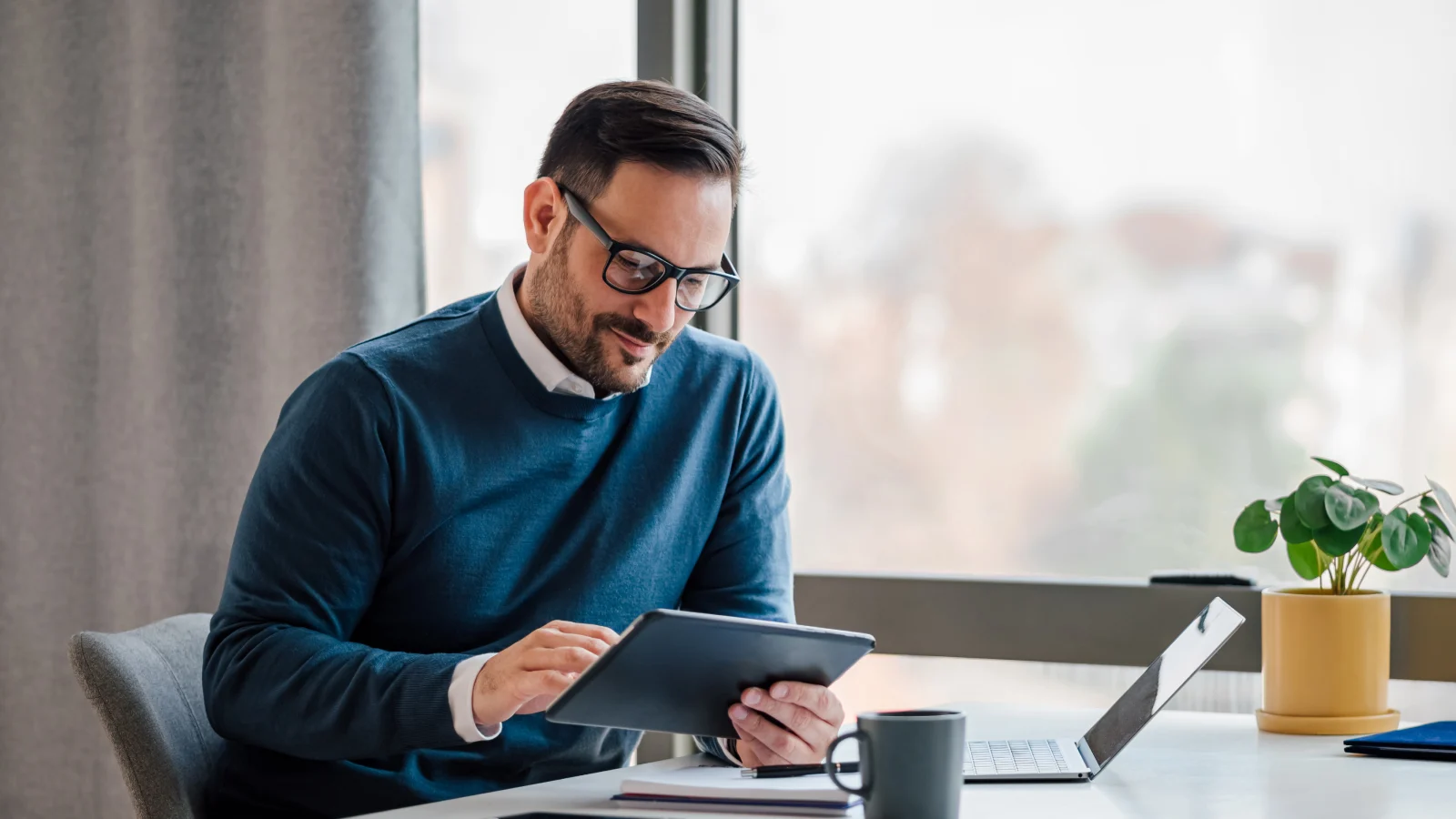 Do you speak finance? The acronyms you should know. - Businessman using digital tablet in office