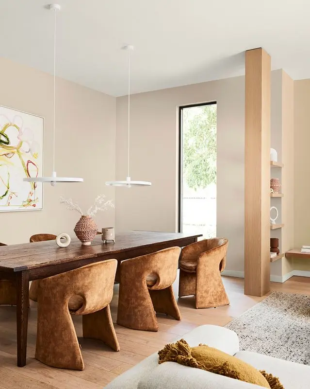 Wooden dining table in neutral room painted with Dulux Buff it and Skip To.