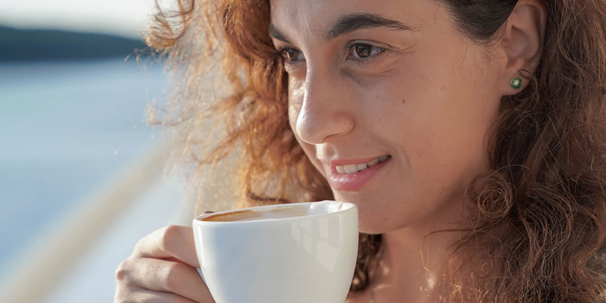 Woman drinks coffee onboard Woman drinks coffee onboard