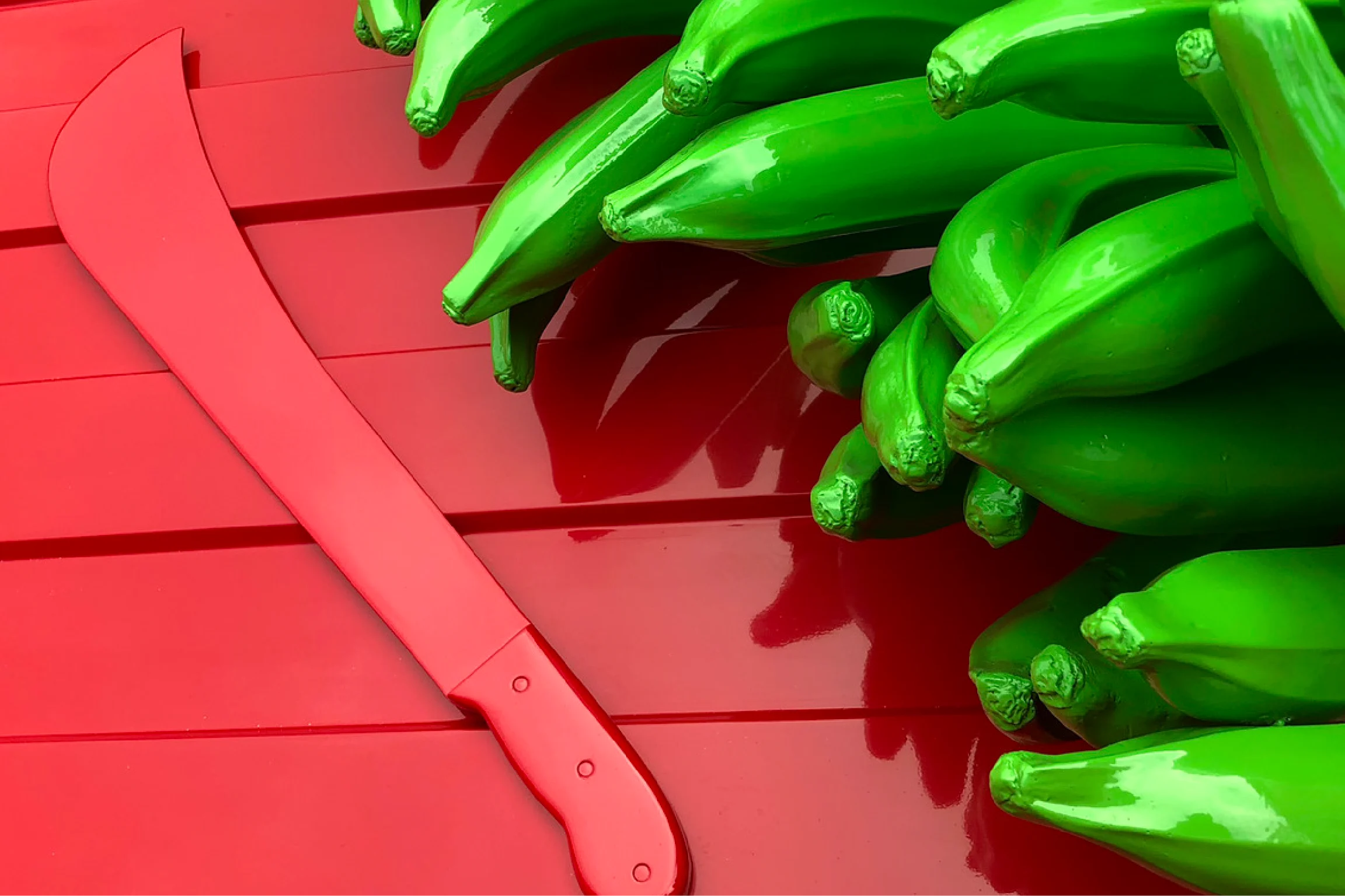 In the event art for Puerto Rico Now, a machete sits on a table with a bunch of bananas