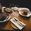 Food and wine on wooden table in a restaurant.