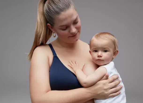 Woman wearing navy nursing bra. Book a nursing bra fit