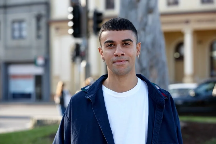 Young Indigenous man standing in a park