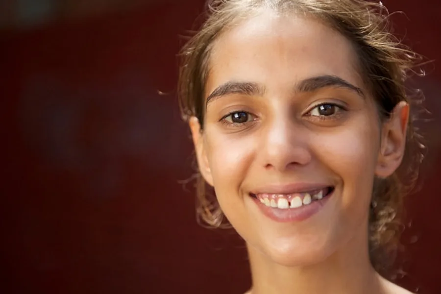 girl smiling with brown background