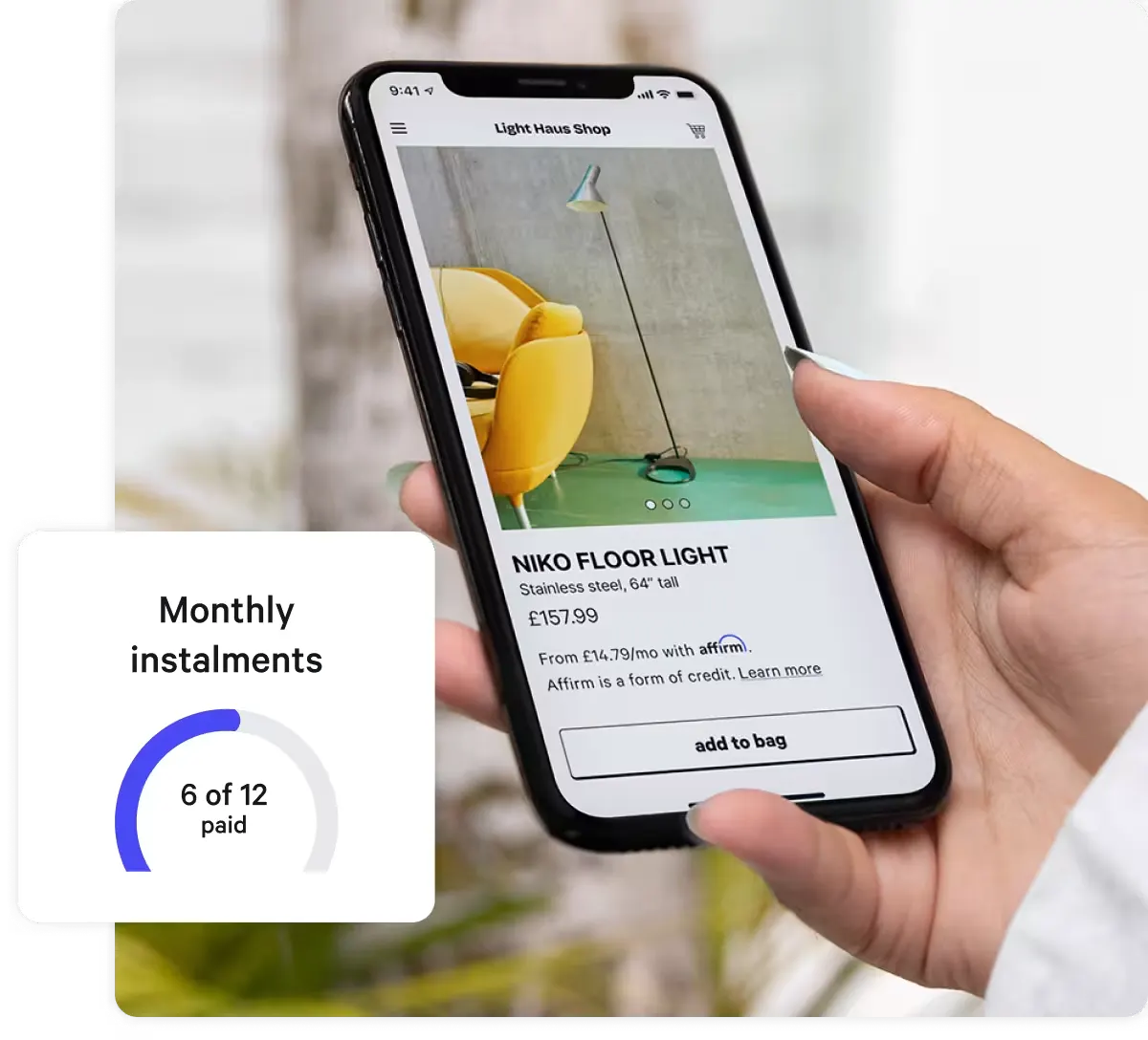 Close-up of a person's hand holding a smartphone displaying an online shopping app. The screen shows a product listing for a 'Niko Floor Light' priced at £157.99, with financing options available through Affirm. In the bottom left corner, a progress tracker indicates '6 of 12 monthly installments paid' in a circular graphic.