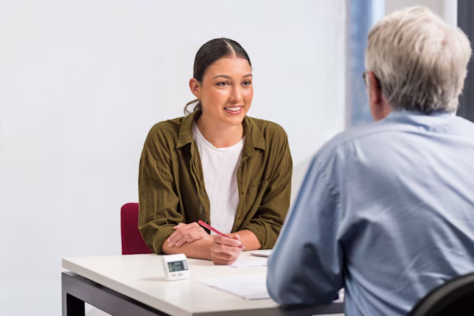 Female test taker speaks to a male IELTS examiner during the IELTS Academic Speaking test