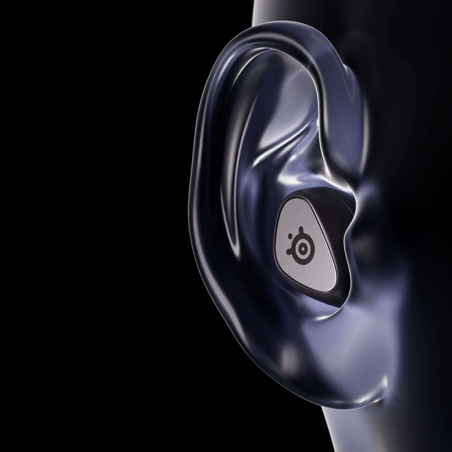Visible large ear of the mannequin with a black Arctis Gamebuds headset.