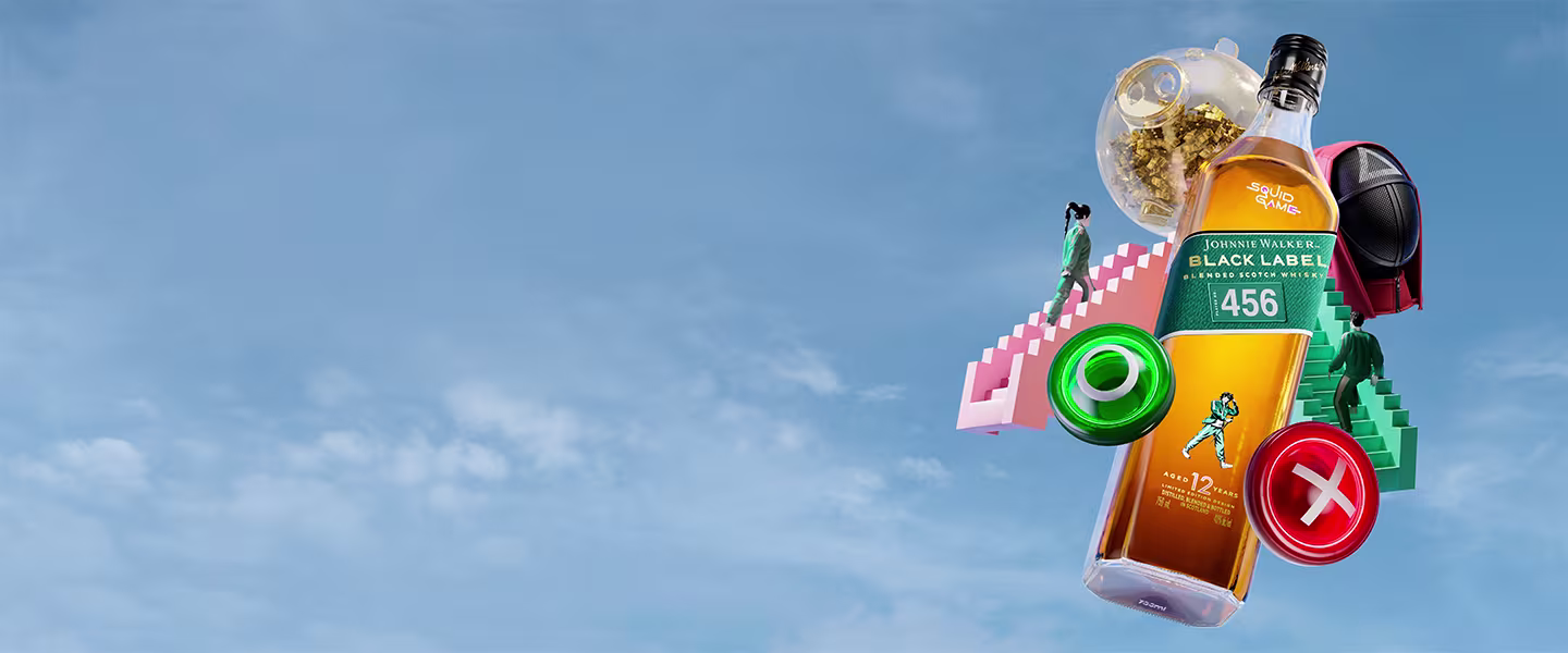 A bottle of Johnnie Walker Black Label whiskey with a whimsical design featuring colourful stairs, a small figure, and various objects, set against a clear blue sky background.