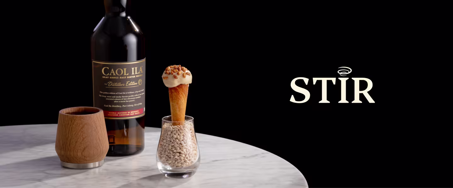 A bottle of Caol Ila Single Malt Scotch Whisky alongside a small dish with a cone-shaped dessert and a glass of barley. The word "STIR" is prominently displayed.