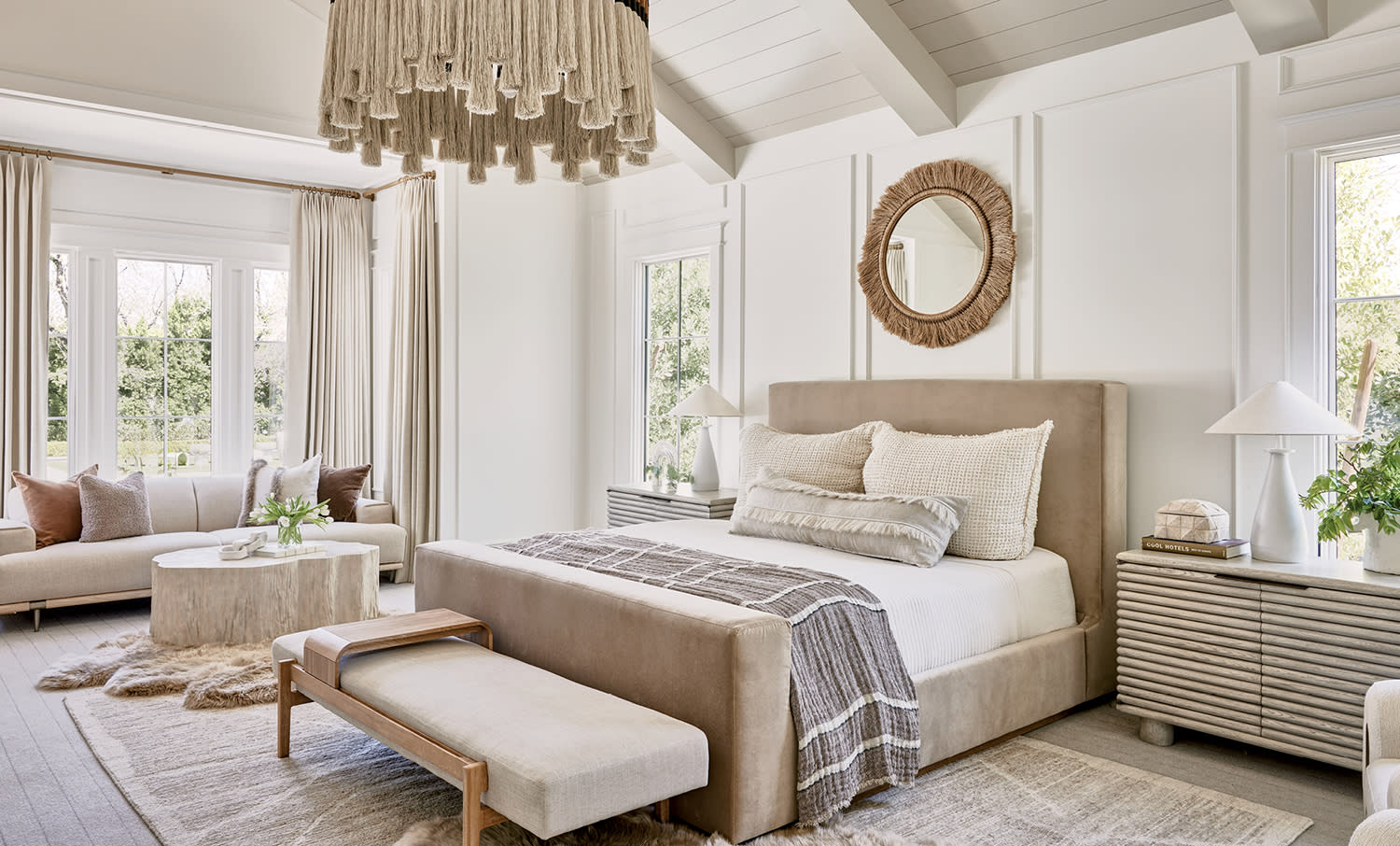 neutral, contemporary bedroom with a tan bed and white walls
